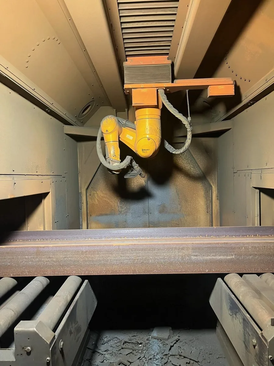 Click to enlarge Peddinghaus PeddiBot-1200 interior showing 6-axis Staubli TX2 90 robot arm over a steel beam