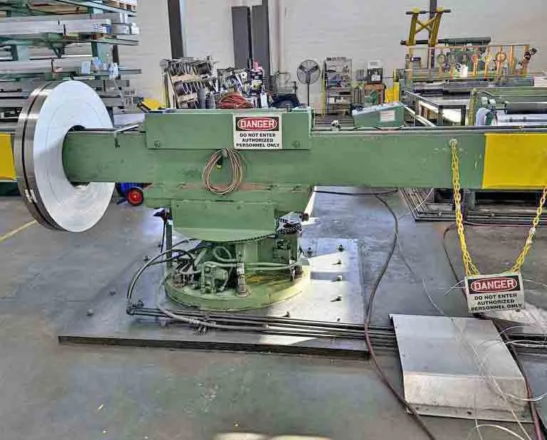 Stamco slitting line - two-arm exit turnstile with C-hook arms and coil